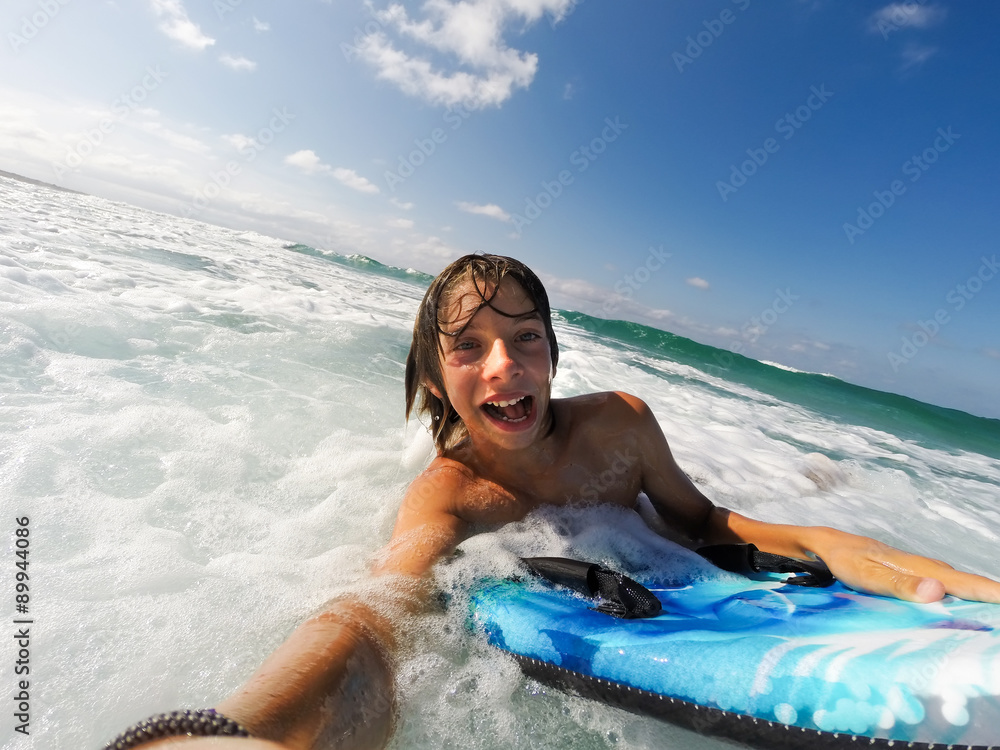  boy enjoys riding the waves with a surfboard