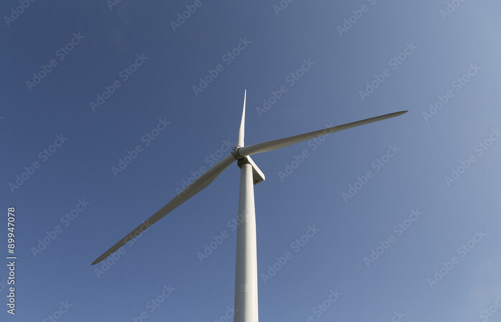 An isolated wind turbine on a blue canvas An isolated wind turbine on a blue canvas