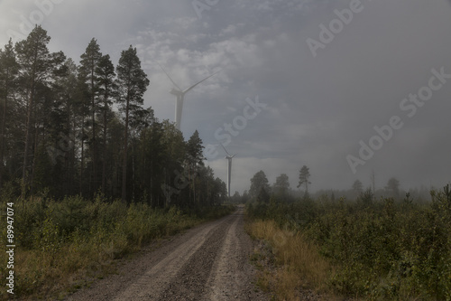 Two turbines on a road with foggy conditions © lasselund