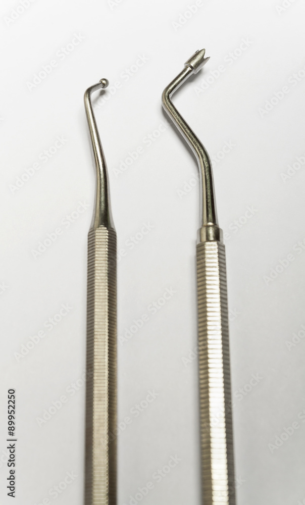 Chromed dental equipment on a blank white background. Two different ends of the dental tools. Chromed dental equipment on a blank white background. Two different ends of the dental tools.