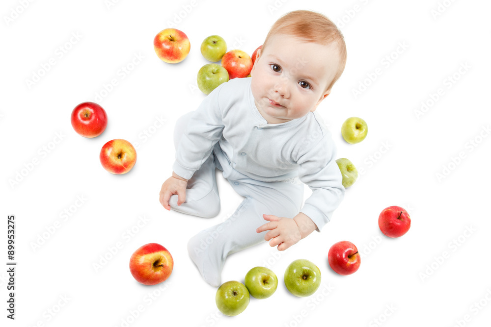 Baby plays with apples. Studio Portrait , isolated on a white background Baby plays with apples. Studio Portrait , isolated on a white background