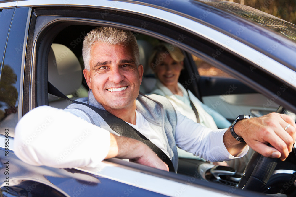 middle aged couple driving a car middle aged couple driving a car