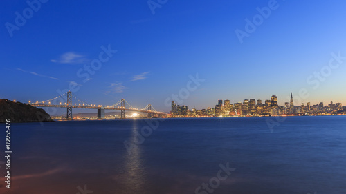 San Francisco – Oakland Bay Bridge with lights at sunset time © Kit Leong