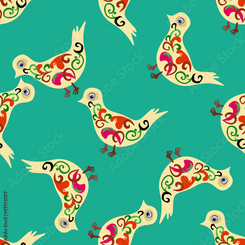 Beautiful birds in folk style over green background. © aleksandranazim
