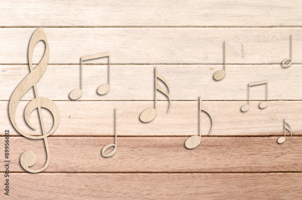 Obraz premium Music notes on wood background.