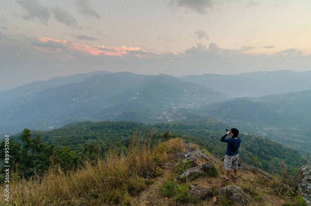 Photographer shooting the beautiful landscape of the Thailand evening mountains.