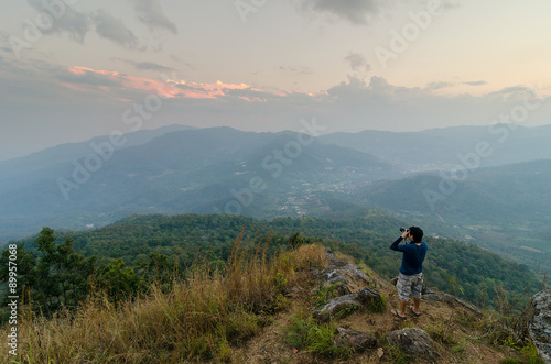 Photographer shooting the beautiful landscape of the Thailand evening mountains. © fongleon356