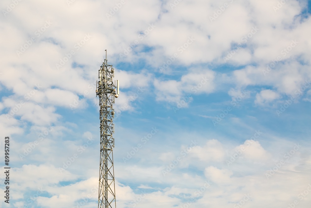 Telecommunication antenna on blue sky with clouds background Telecommunication antenna on blue sky with clouds background