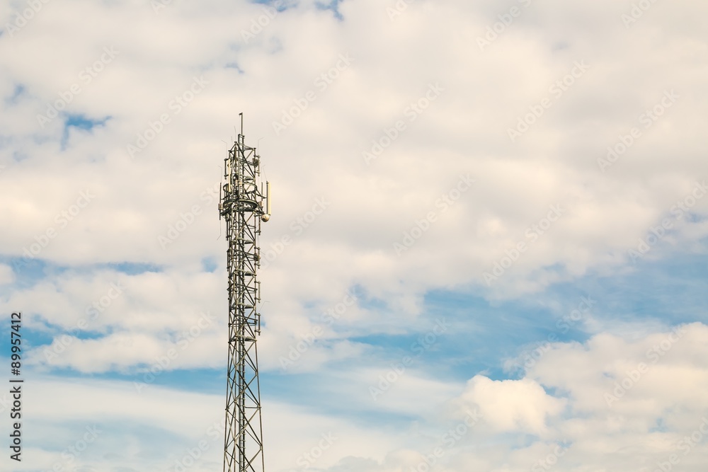 Telecommunication antenna on blue sky with clouds background Telecommunication antenna on blue sky with clouds background