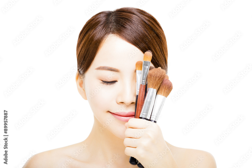 Fototapeta premium young beautiful woman with Makeup Brush