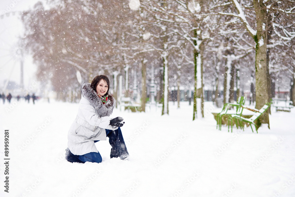 Girl enjoying rare snowy winter day in Paris