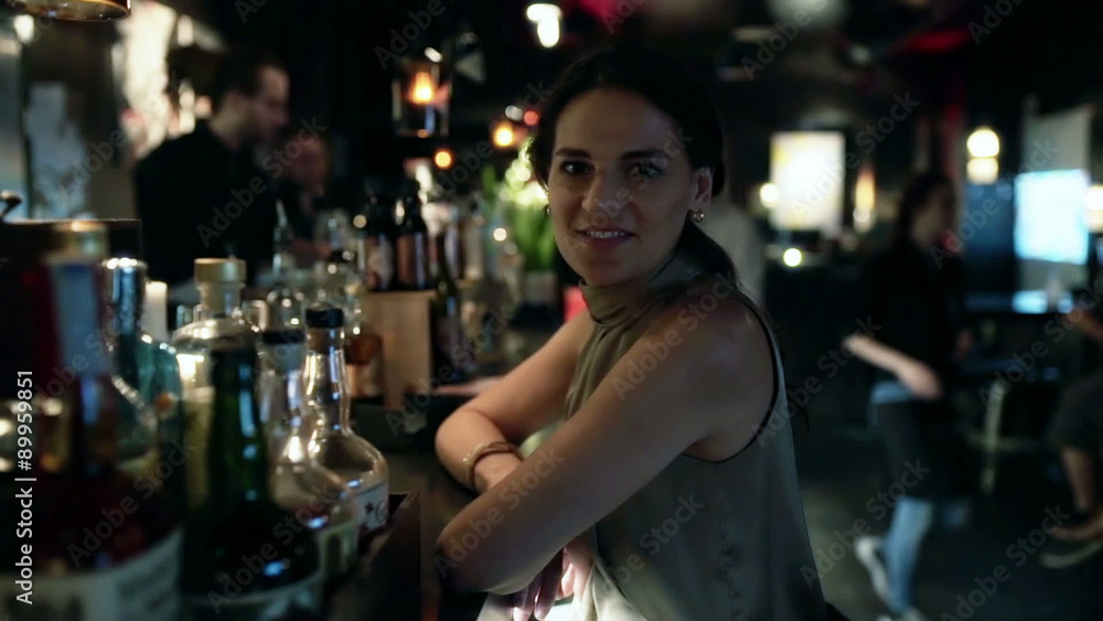 Woman standing in the pub and smiling to the camera, steadycam shot
Woman standing in the pub and smiling to the camera, steadycam shot