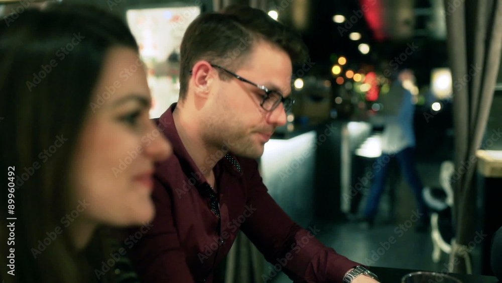 Couple sitting in the pub and drinking beer, steadycam shot
Couple sitting in the pub and drinking beer, steadycam shot
