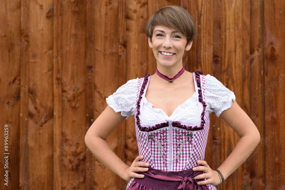 Fototapeta premium Smiling confident German lady wearing a dirndl