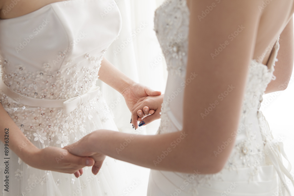 Two brides are willing to connect the hands Two brides are willing to connect the hands