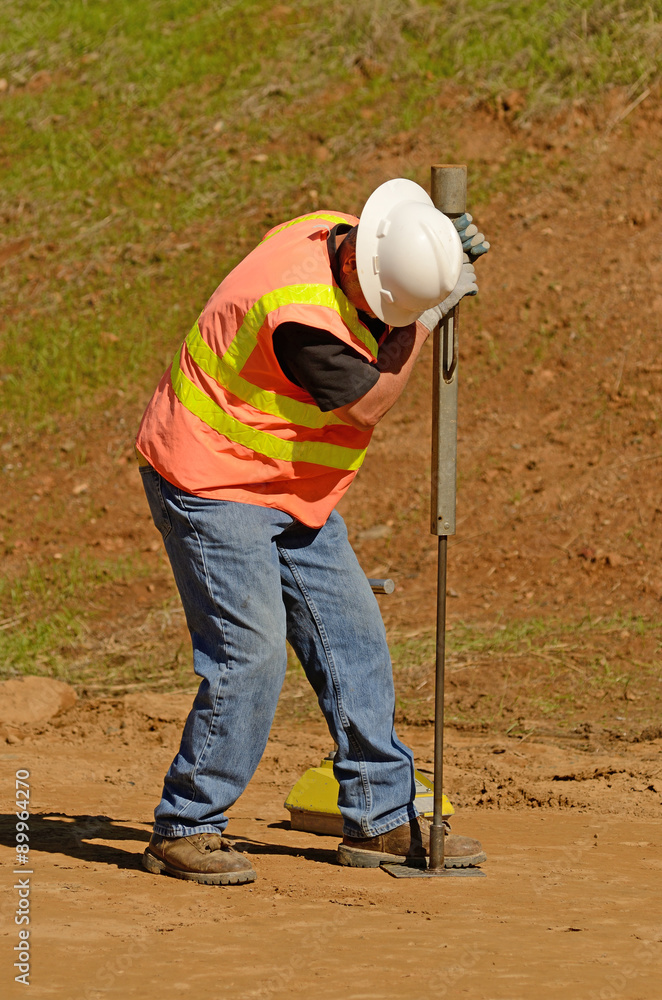 Engineer using a Nuclear Density Gauge to check for soil density of a Engineer using a Nuclear Density Gauge to check for soil density of a