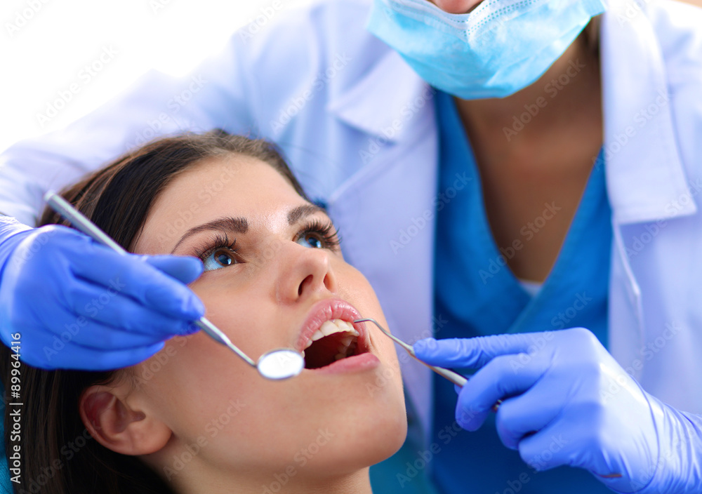 Woman dentist working at her patient's teeth Woman dentist working at her patient's teeth