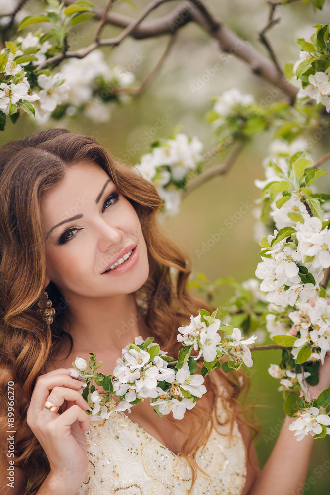 Young beautiful brunette woman in blooming garden Young beautiful brunette woman in blooming garden