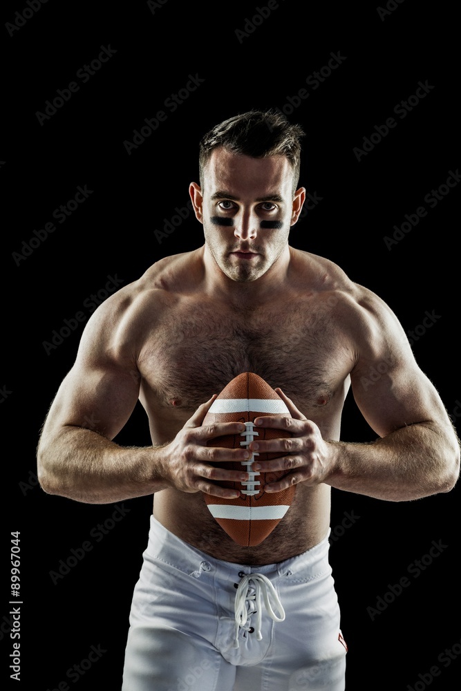 Shirtless American football player with ball Shirtless American football player with ball