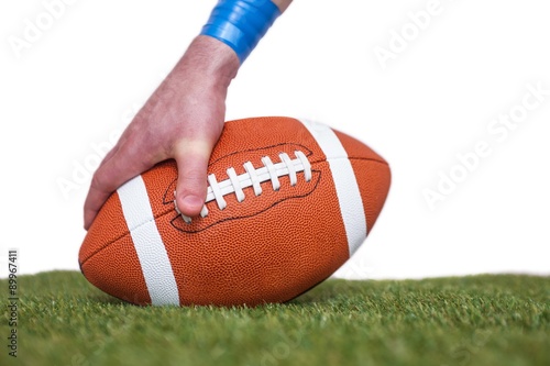 American football player placing the ball