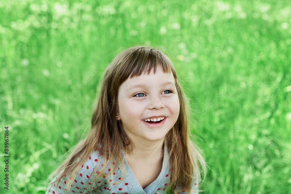 cute little girl laughing on the green meadow outdoor, happy childhood concept, child having fun, vintage toned cute little girl laughing on the green meadow outdoor, happy childhood concept, child having fun, vintage toned