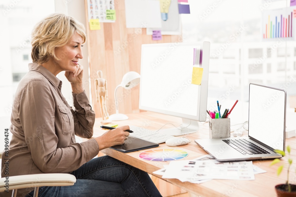 Casual designer working at her desk Casual designer working at her desk