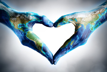 earth's day celebration - hands shaped heart with world map
