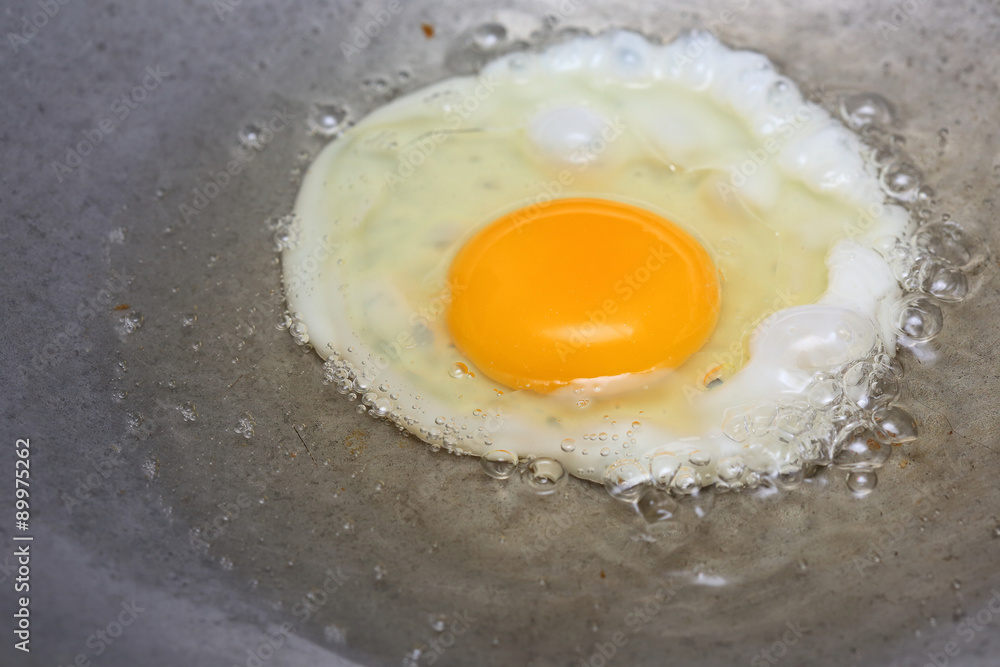 cooking fried egg in hot pan with oil cooking fried egg in hot pan with oil