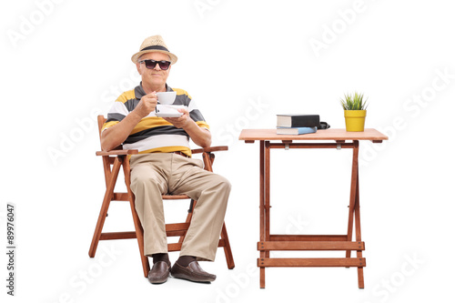 Senior gentleman sitting at a coffee table