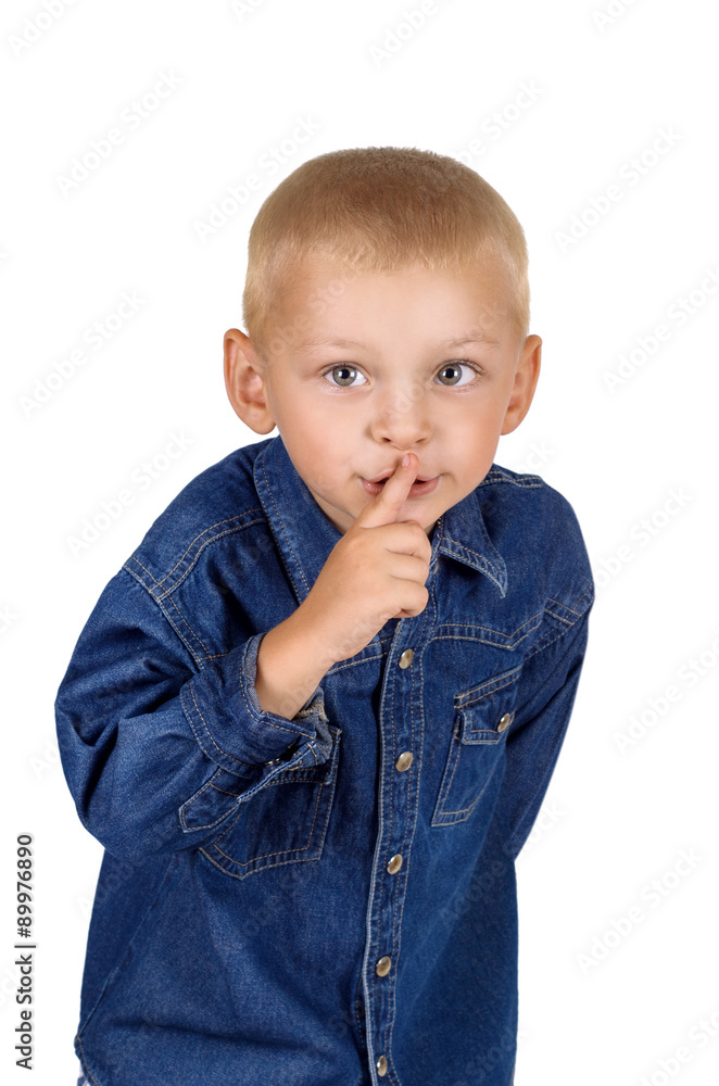 Portrait of a cute little boy making silence gesture in denim blue shirt isolated on white background Portrait of a cute little boy making silence gesture in denim blue shirt isolated on white background