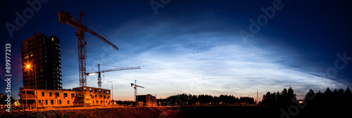 Noctilucent clouds glowing at night sky panorama photo