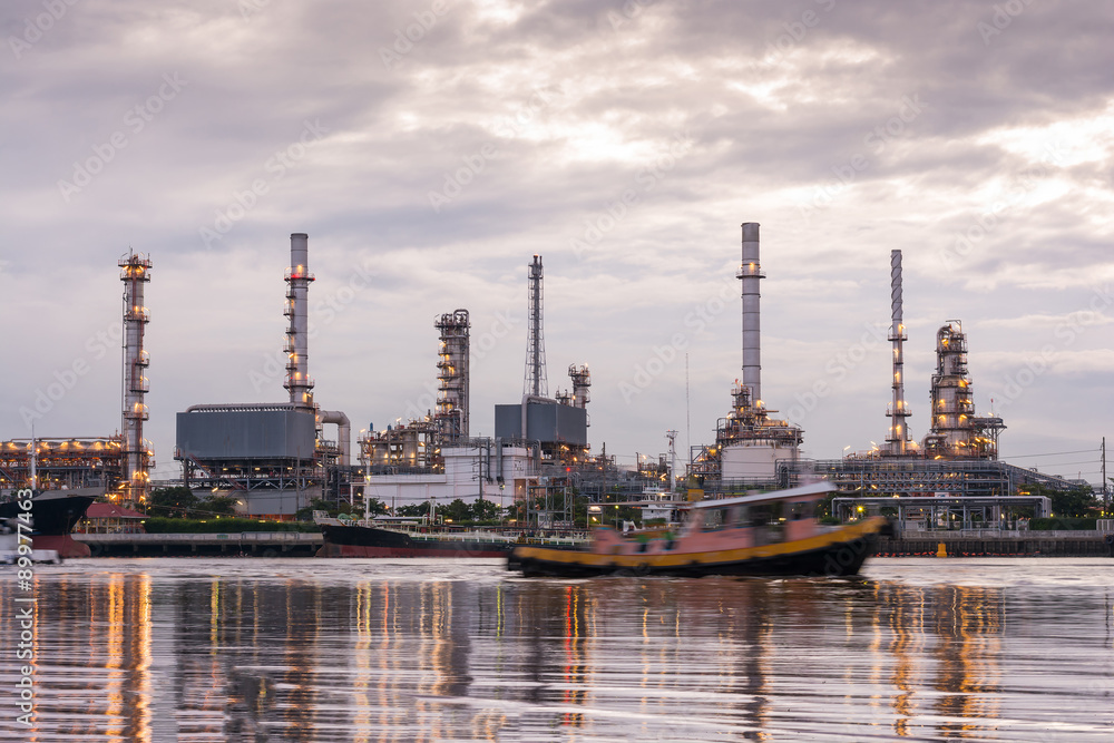 Oil refinery, Tug boats are sailing through oil refinery industr Oil refinery, Tug boats are sailing through oil refinery industr