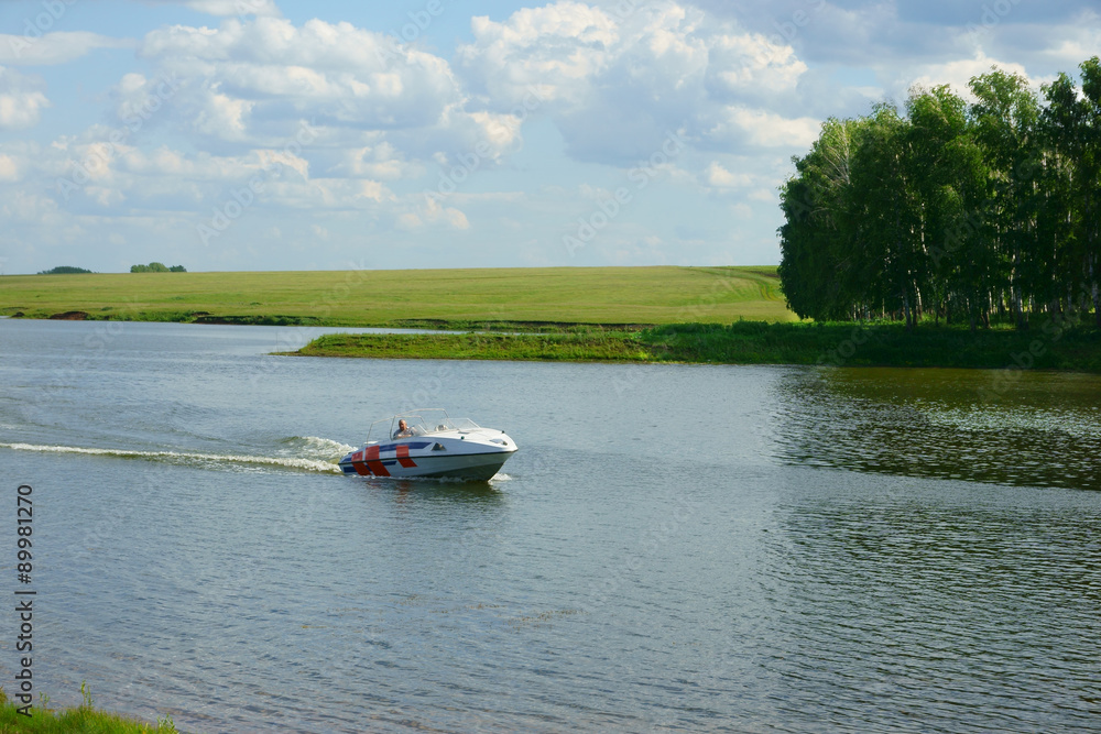 Fototapeta premium man on a boat floating on the lake