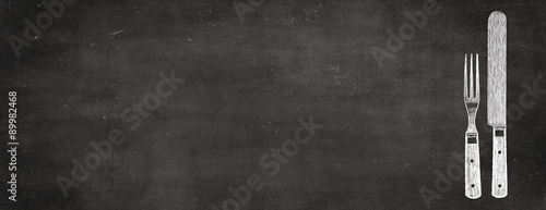 knife and fork on retro blackboard - food and kitchen banner