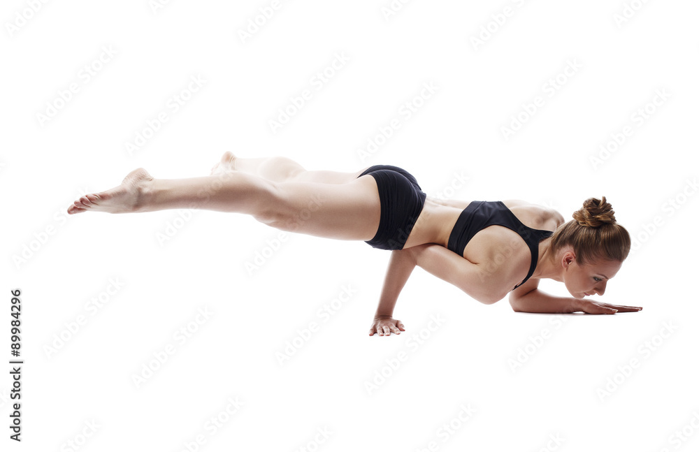 Flexible woman posing in difficult strength pose Flexible woman posing in difficult strength pose