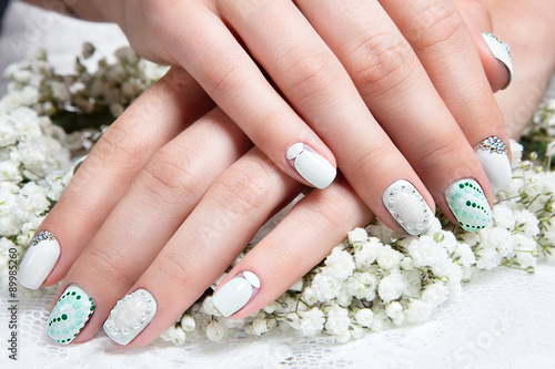 Wedding manicure for the bride in gentle tones with flowers