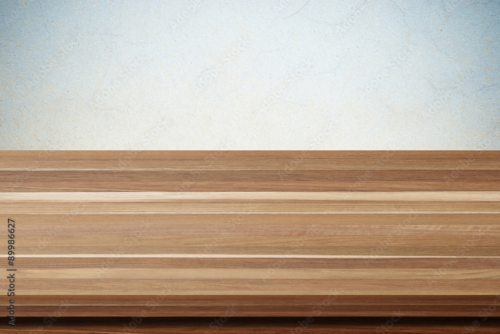 Empty wooden table over grunge cement wall background Empty wooden table over grunge cement wall background