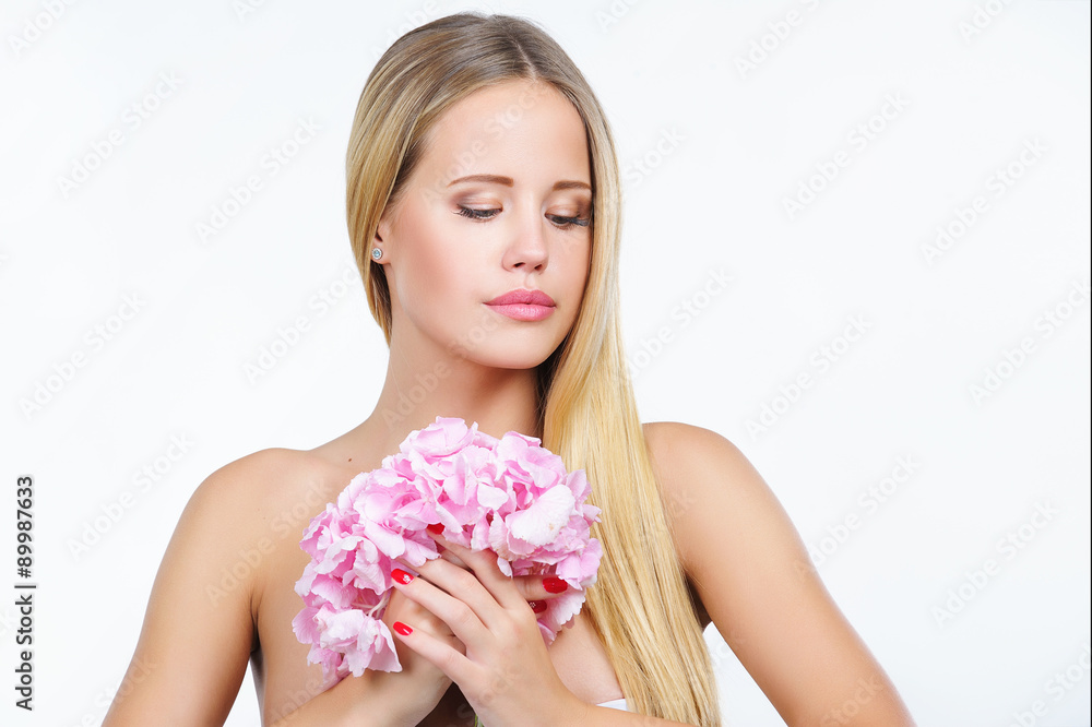 Natural beauty portrait of attractive woman with beautiful fresh skin holding pink flower, isolated on white background