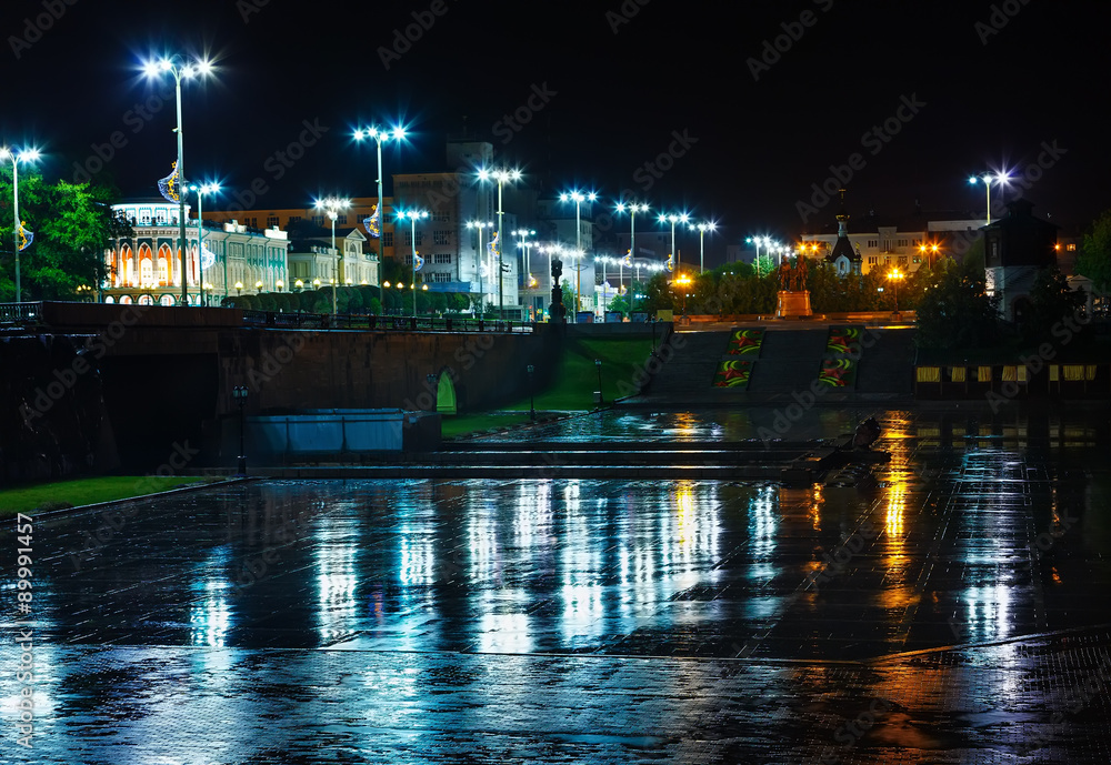 Night lights of city reflected in  wet asphalt