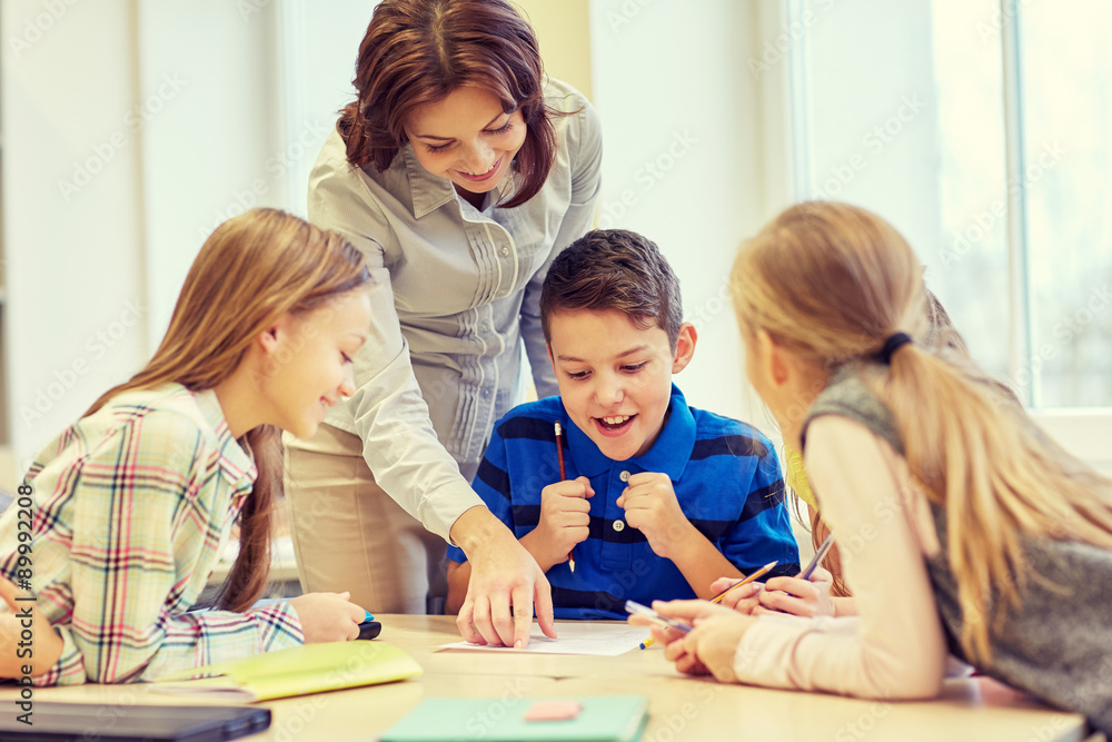group of school kids writing test in classroom group of school kids writing test in classroom