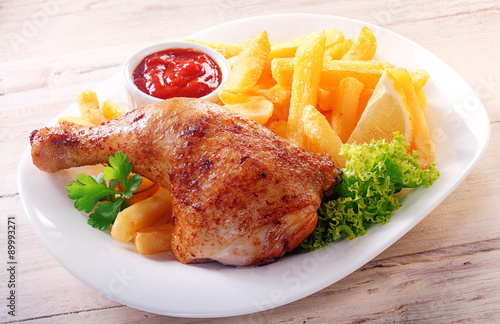 Fotografie Gourmet Tasty Chicken and Fries on a White Plate