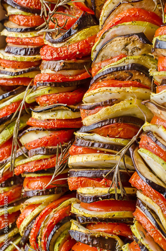 close-up of a vegetarian dish made of aubergine, tomatoes and zucchini in a mixture of satay and ratatouille