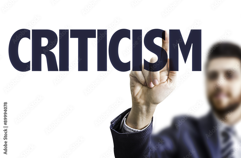 Businessman pointing the text: Criticism Businessman pointing the text: Criticism