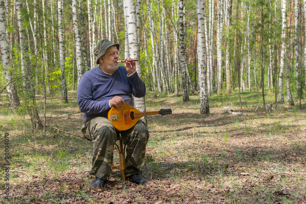 Seniors playing music in birch forest Seniors playing music in birch forest