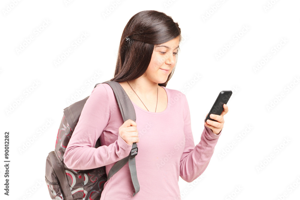 Schoolgirl looking at her cell phone Schoolgirl looking at her cell phone