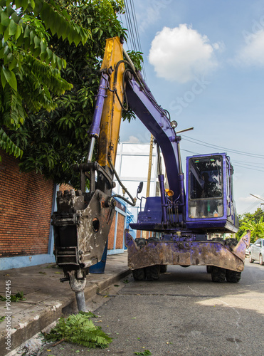 industrial backhoe, bulldozer moving drilling for road construction updates.