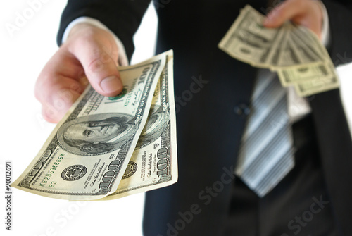 A man in a business suit offers money