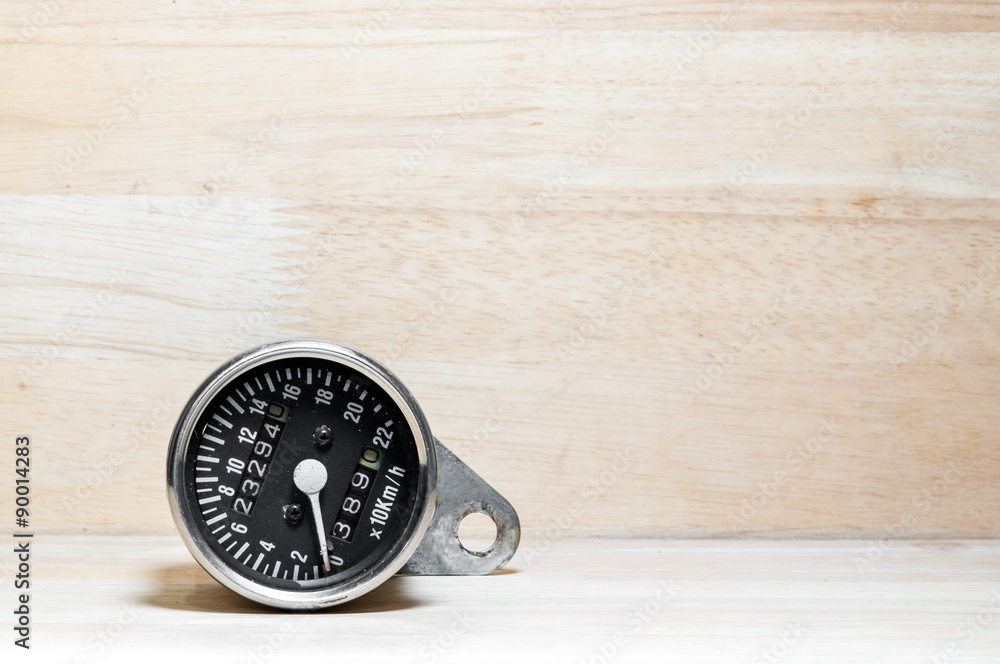 speedometer on wood background speedometer on wood background