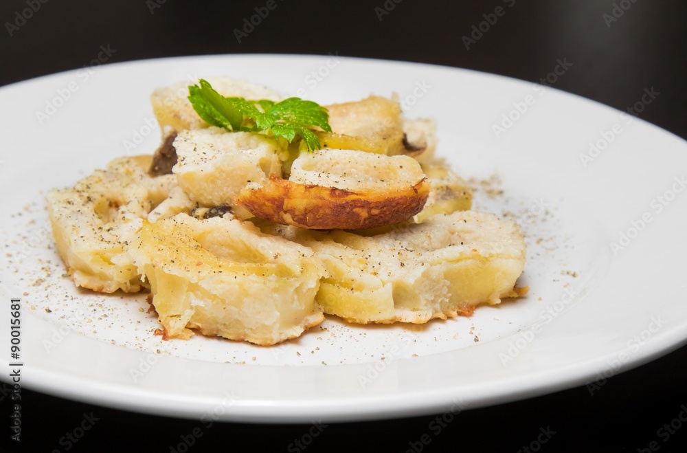 dish of italian swivels pasta with porcini mushrooms and sauce bechamel with pepper