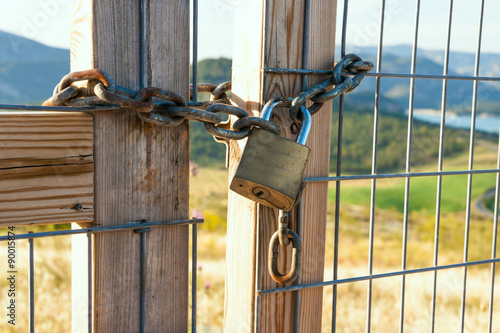 Locked gate on beautiful landscape